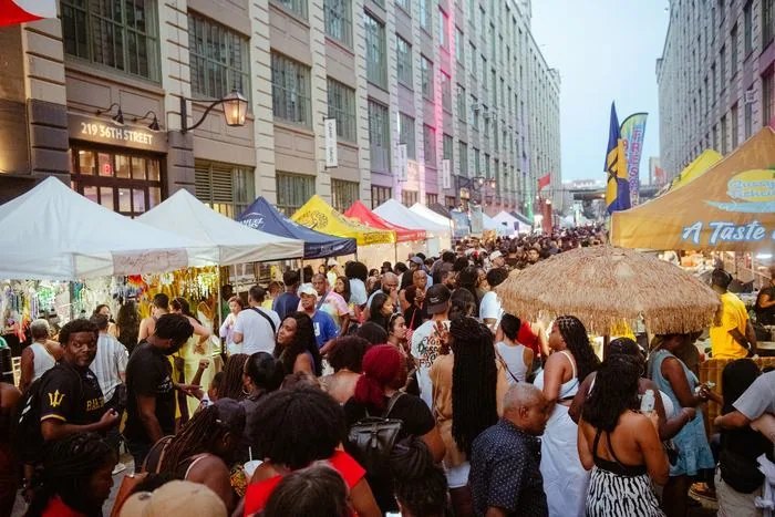 A packed Brooklyn Night Market at Industry City, white tents and a crowd running the length of the block.